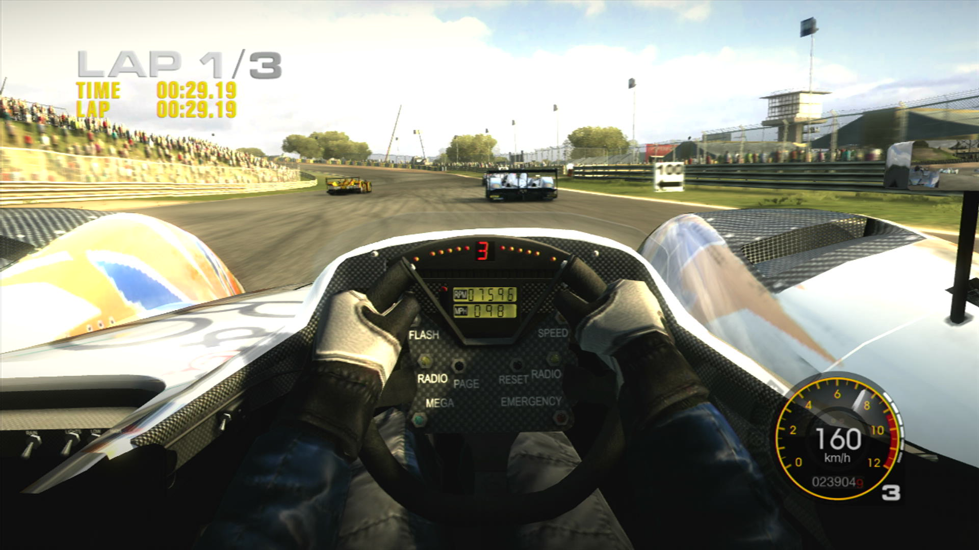 We are in the middle of a race in GRiD at the Jarama circuit, driving the Creation CA06/H with it's V-shaped steering wheel, and some more LMP1 cars ahead.