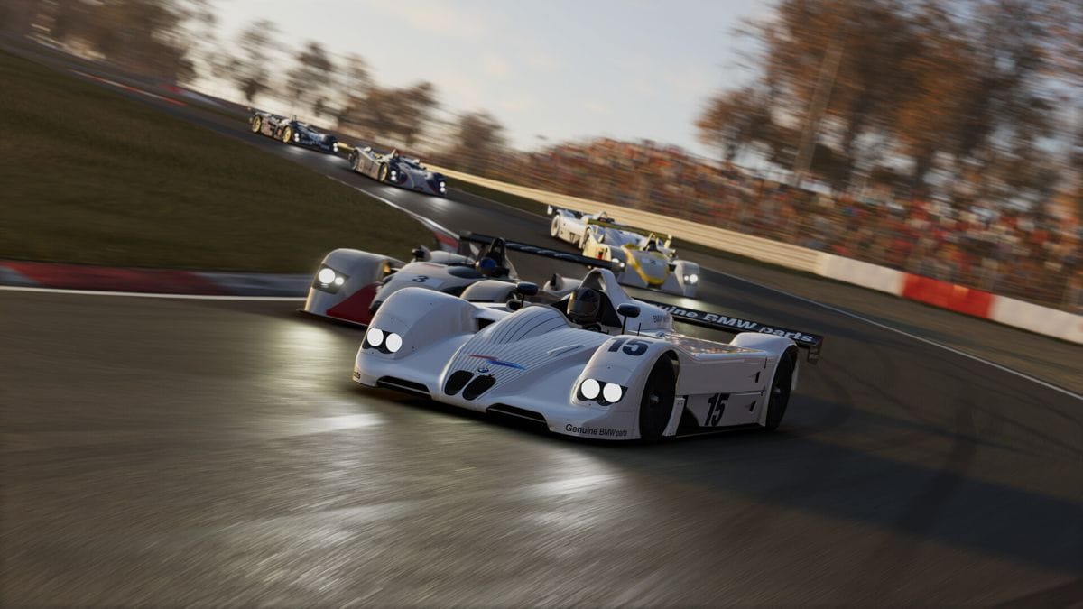 A white BMW V12 LMR open-top prototype leading a field of other Le Mans Prototypes through a right hand corner. It is a screenshot from Project Motor Racing.