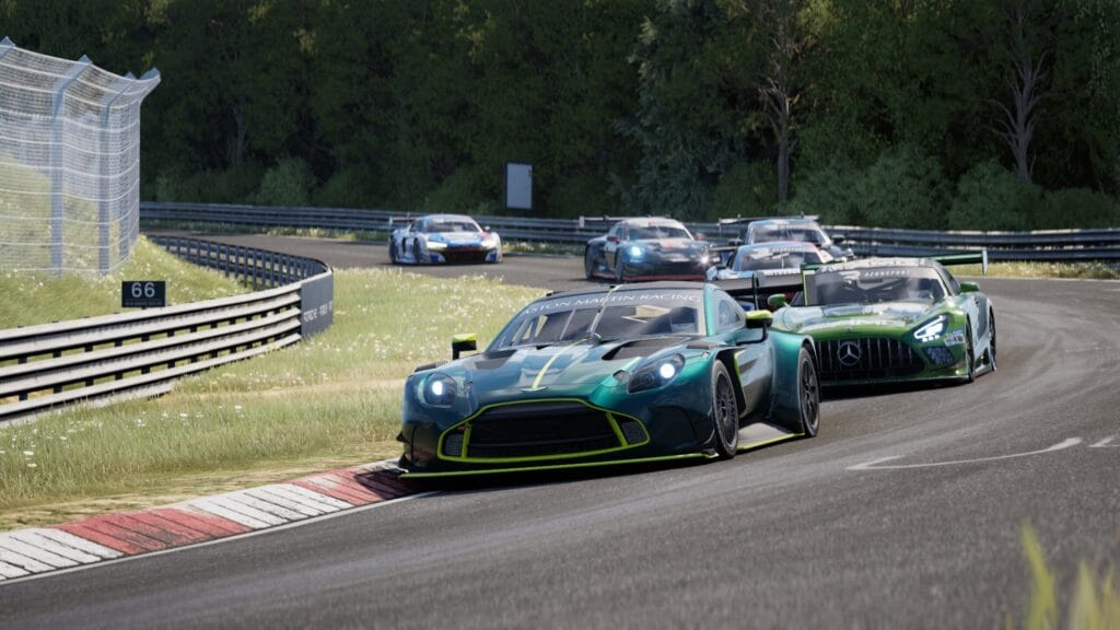 Six GT3 cars racing in close proximity on the Nurburgring Nordschleife in Rennsport, being led by a Aston Martin Vantage GT3 in British racing green. 