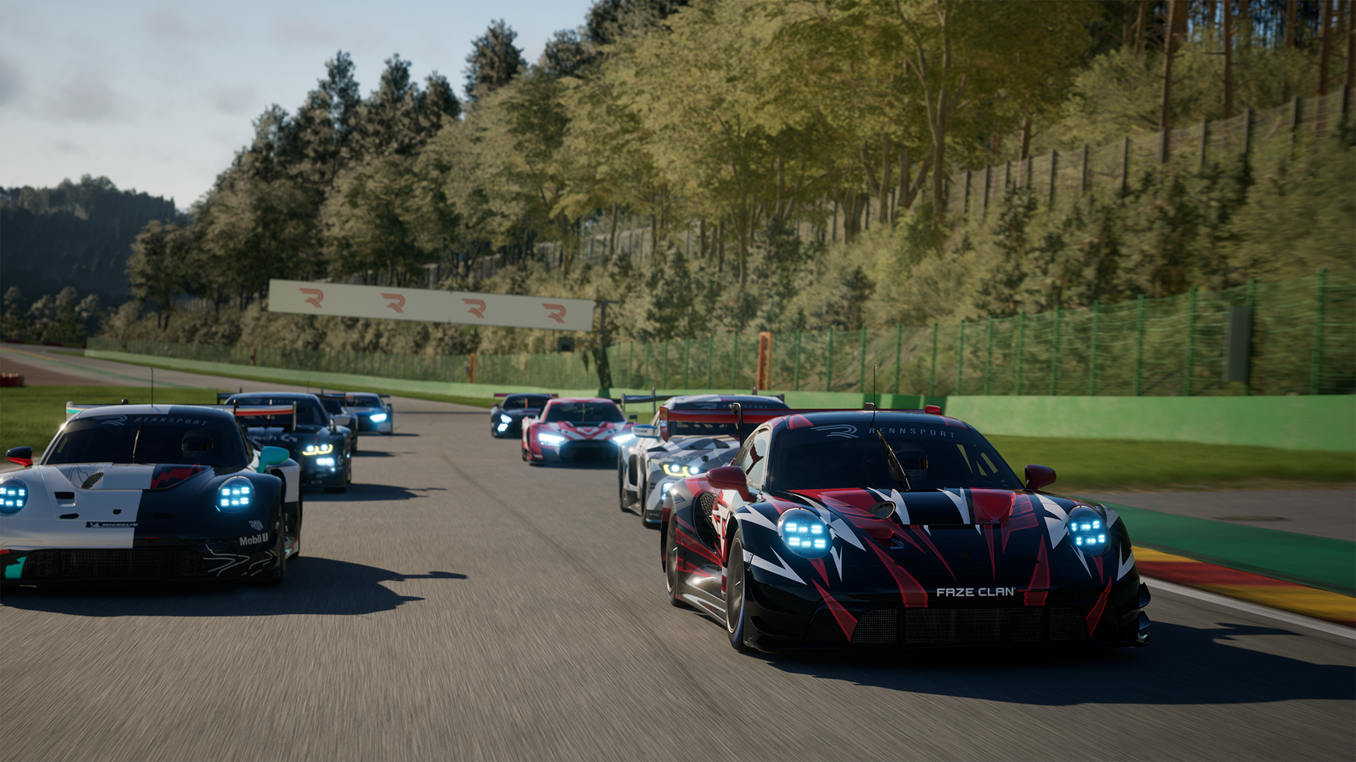 Eight GT3 class race cars in four rows of two head to the final chicane at the end of a lap at Spa-Franchrochamps before a race in Rennsport. The Porsche 911 GT3 R in focus is black, with red and white and says FAZE CLAN on the front bumper.