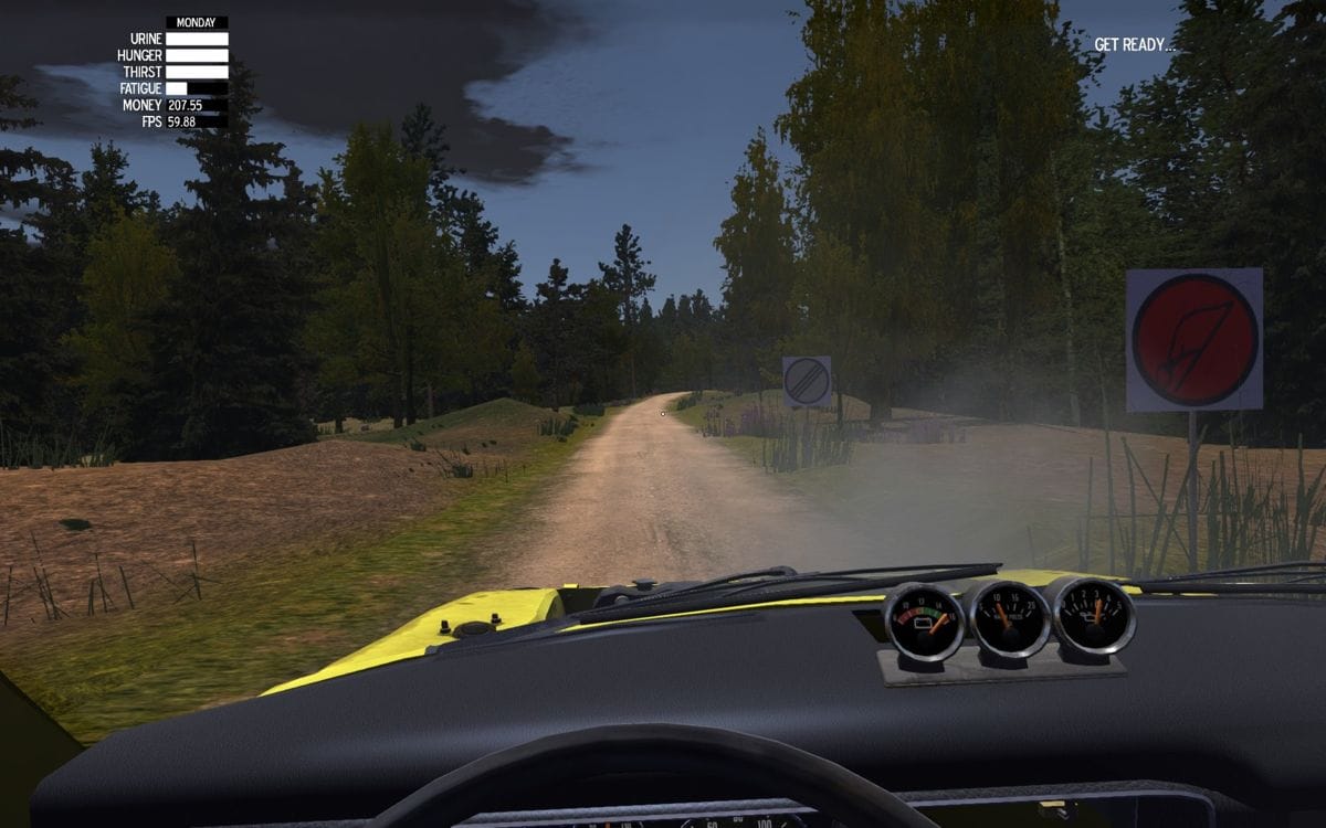A pov view behind the wheel of the Satsuma from My Summer Car. They are at the start of the rally stage, indicated by the stage signs on the right. The Satsuma is missing it's hood and there's smoke billowing out from the engine.