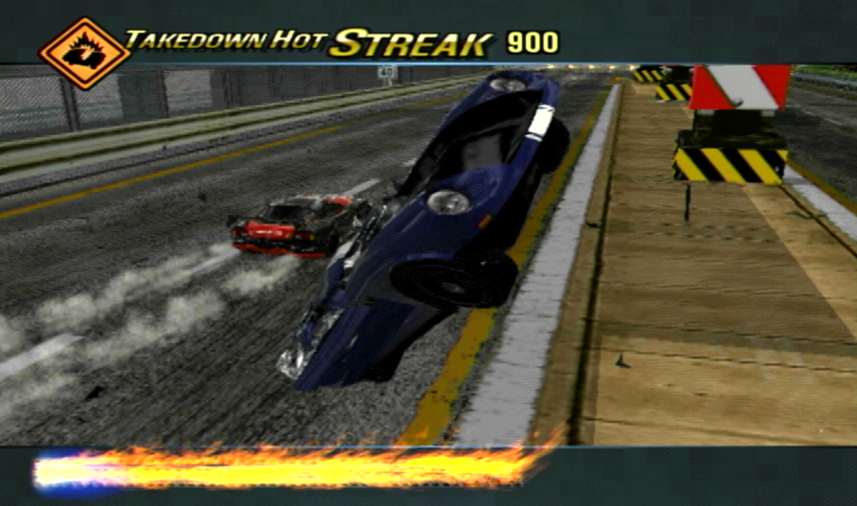 The cinematic for scoring a Takedown in Burnout 3: Takedown, showing off the blue muscle car mid-crash as you drive away in the background.